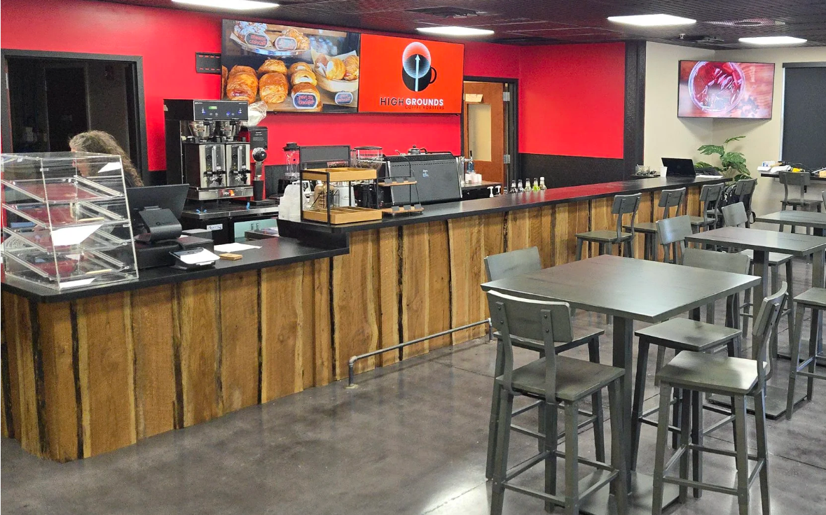 Inside High Grounds Lounge — live-edge wood counter, espresso bar and metal bar seating